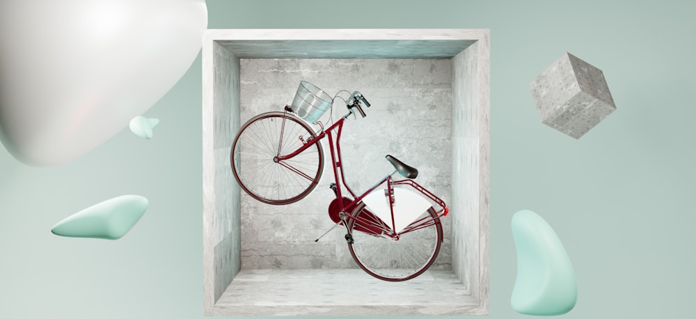 a red bicycle in a white box surrounded by other objects