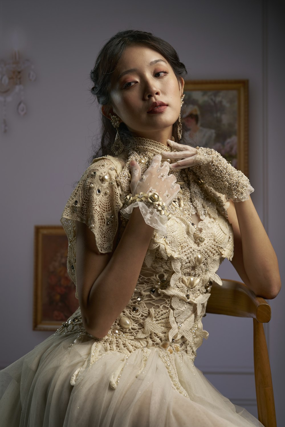 a woman sitting in a chair wearing a dress