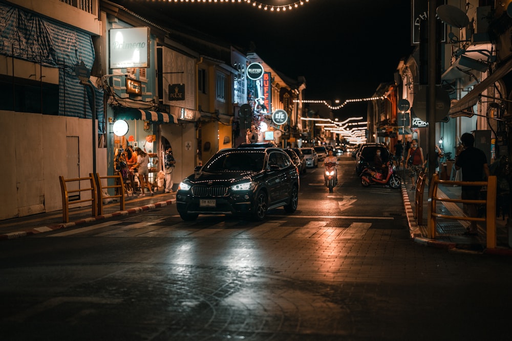 a car driving down a city street at night