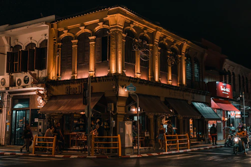 a group of people standing outside of a building at night
