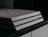 A close-up image of a Sony PlayStation 4 gaming console, featuring a sleek, tiered design with a matte finish and the Sony logo imprinted on the front.