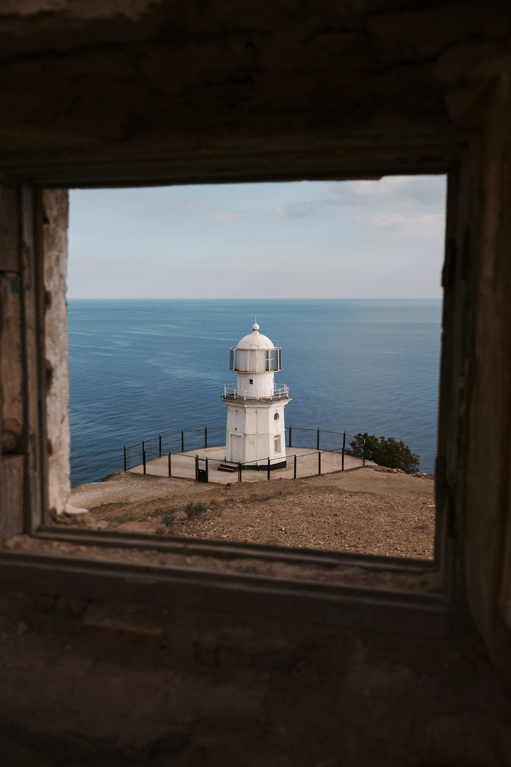 a view of a lighthouse through a window