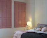 A cozy bedroom setup with a stylish bed and soft pastel bedding.