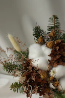 Arrangement of Bosquevivo products on a warm earth-toned fabric with sprigs of native herbs.