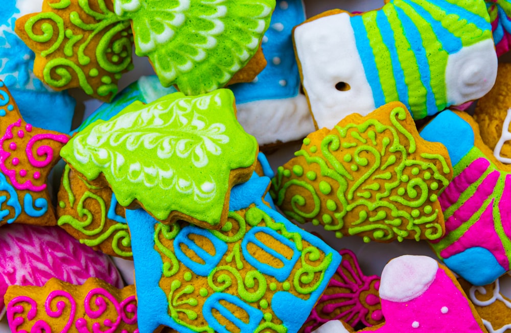 a pile of decorated cookies sitting on top of a table