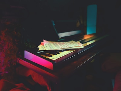 A softly lit piano keyboard bathed in warm amber light, evoking calm and introspection.