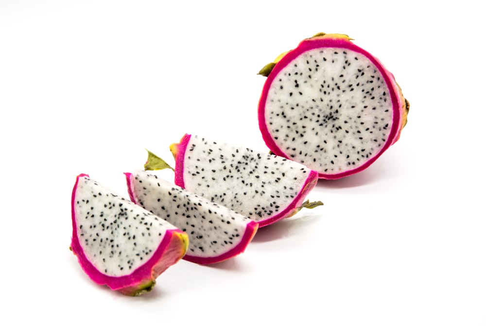 a cut in half dragon fruit on a white background