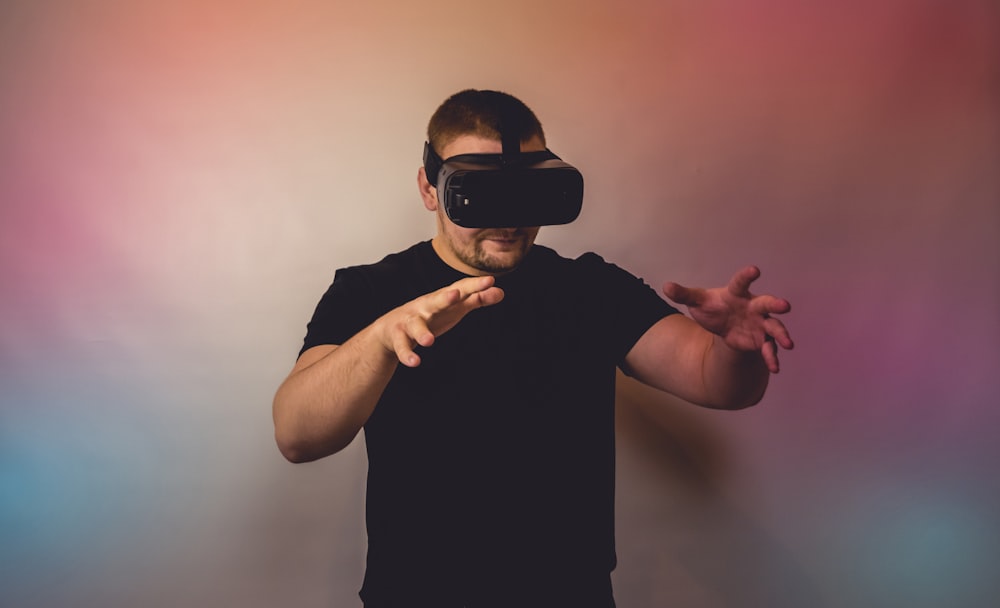 a man in a black shirt is using a virtual device