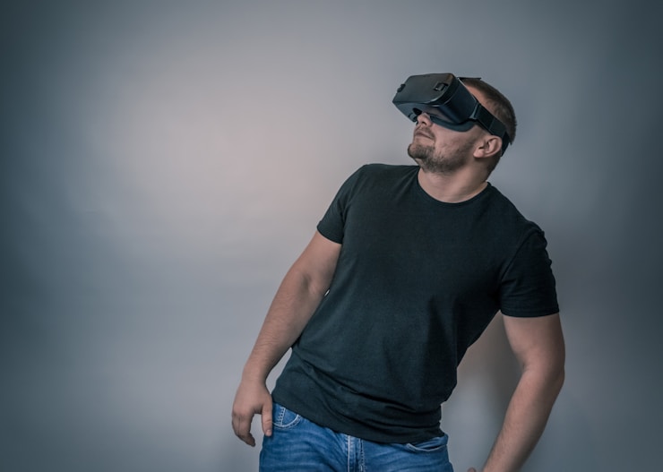 Young man with virtual reality glasses. Modern technologies. Image contains excessive noise, film grain, compression artifacts and posterization due to special treatment. More of my photos and videos Adobe Stock:http://bit.ly/3RqlciK More of my photos and videos Shutterstock: https://www.shutterstock.com/g/ALEKSANDRBERDYUGIN My email: bermix999@gmail.com