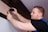 a man working on a wall with a screwdriver