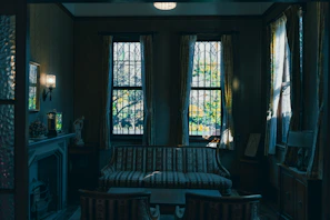 Elegant living room with large windows and tasteful decor in a Nancy apartment.