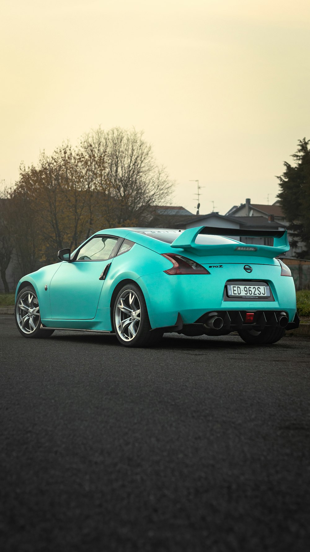 a blue sports car parked on the side of the road