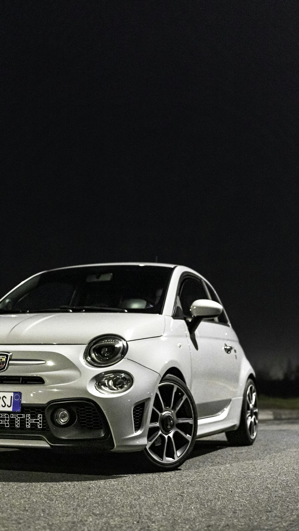 a white car parked on the side of a road