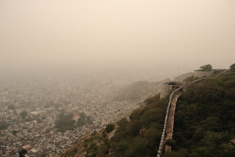 a foggy view of a city from the top of a hill