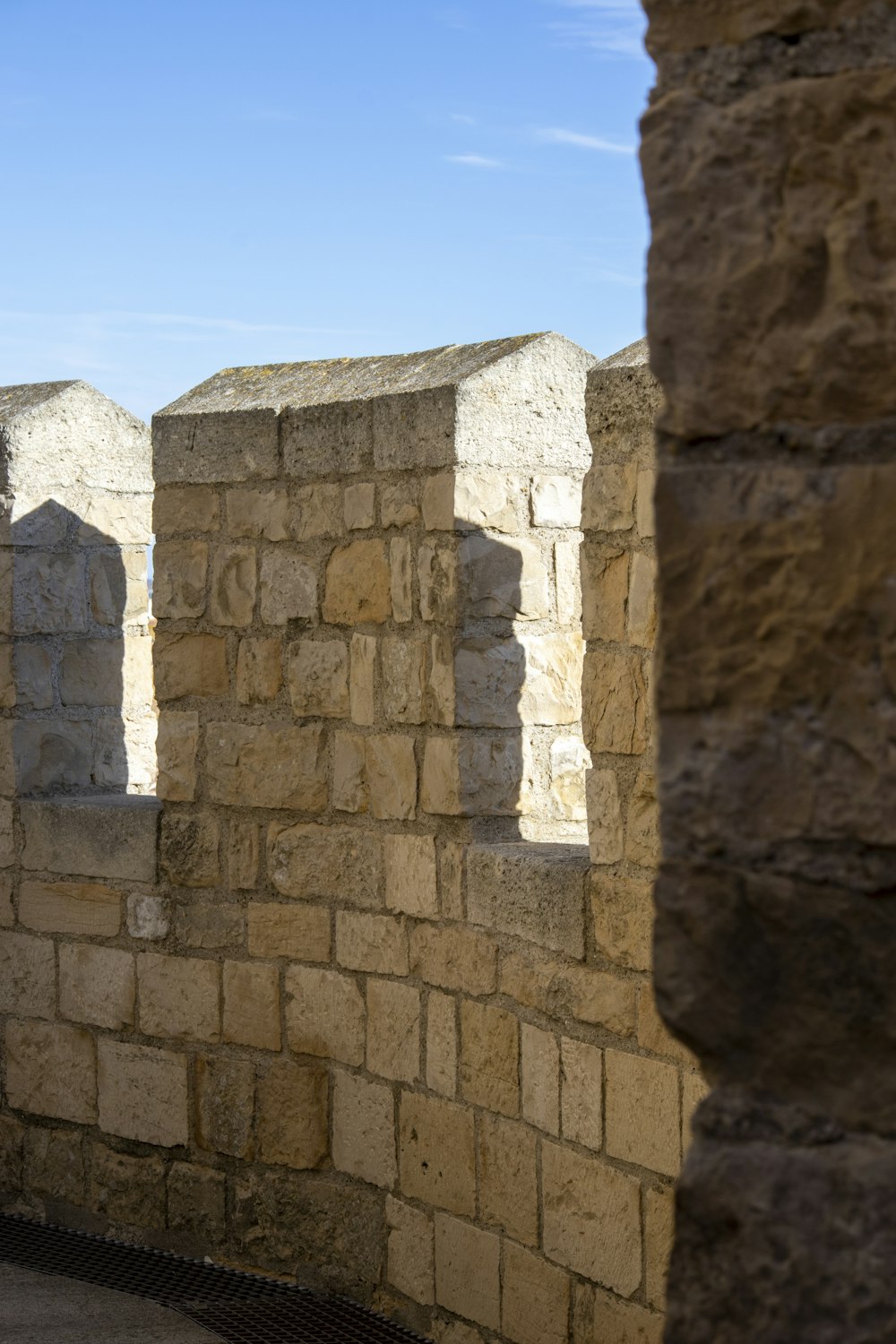 a stone wall with a clock on the side of it