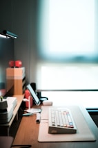 A minimalist desk setup featuring a tablet showing a tech article, bathed in natural light.