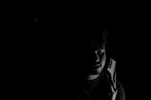 Anonymous tip submission form on a mobile device in a dimly lit setting.