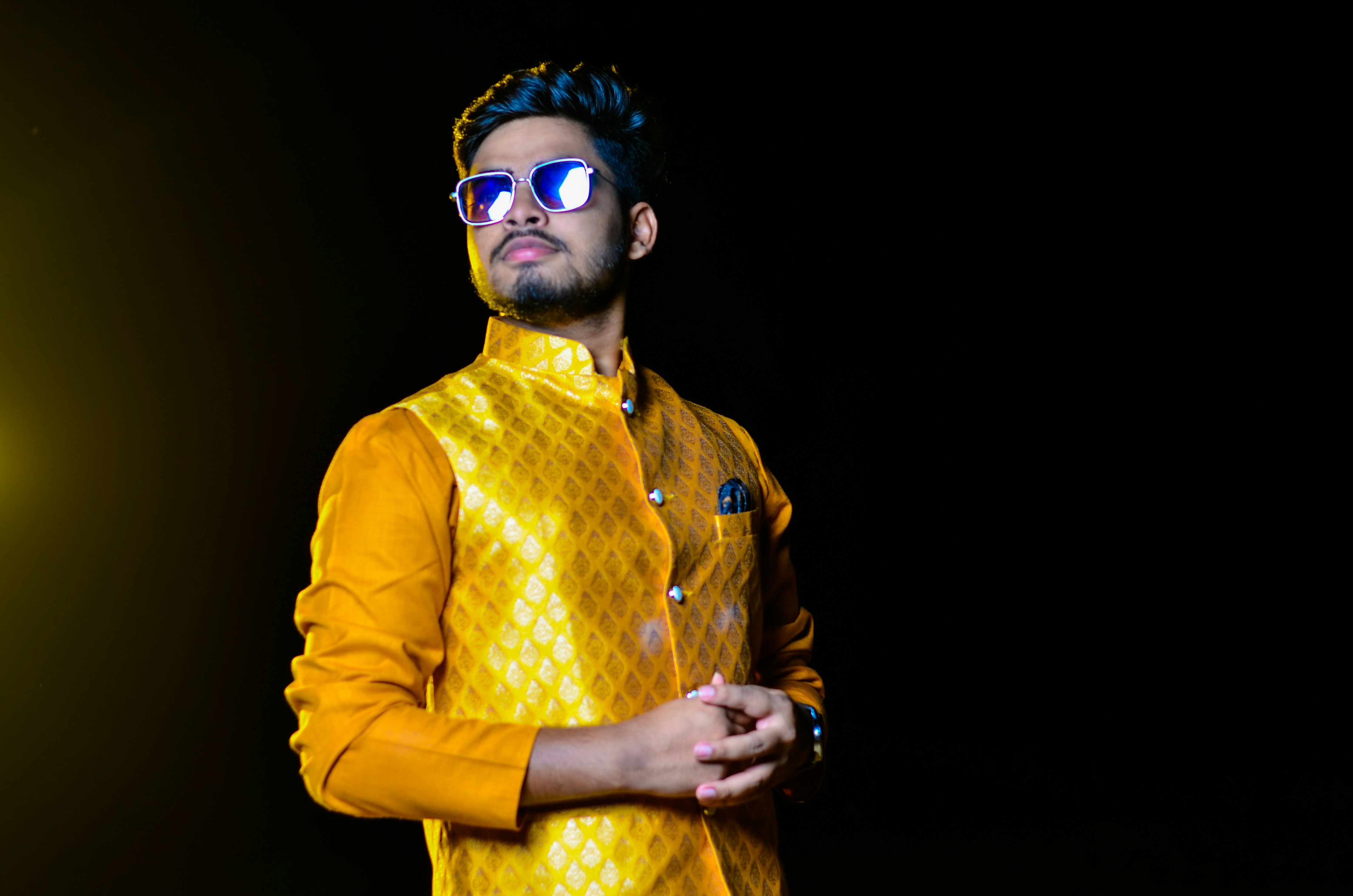 Man in cream embroidered kurta, soft warm natural light, minimal airy interior
