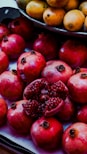 a pile of pomegranates sitting on top of a table