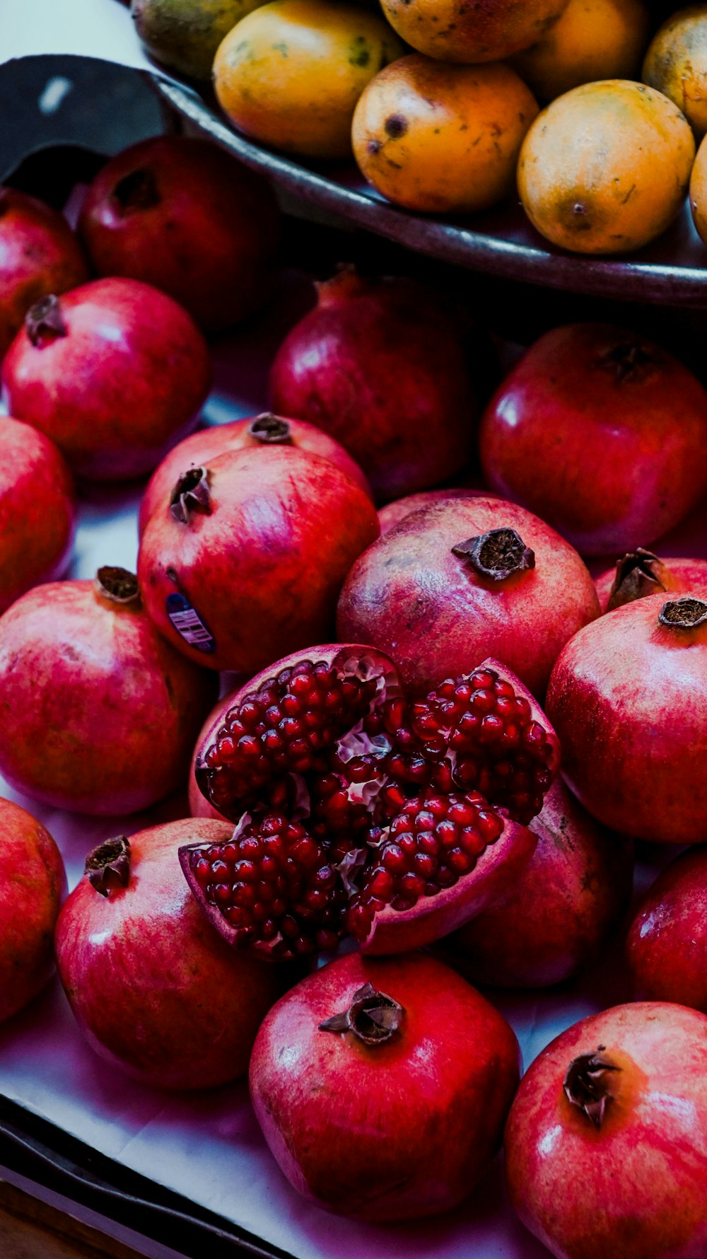 a pile of pomegranates sitting on top of a table