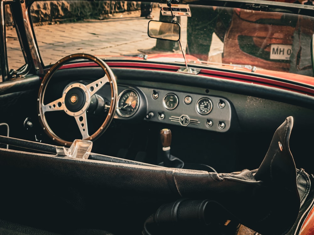 an old car with a steering wheel and dashboard