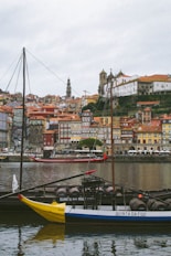 a blue and white boat sitting on top of a body of water