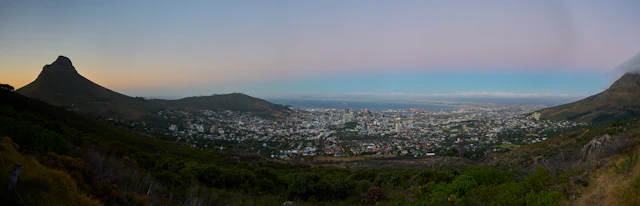 A dusk panorama of Cape Town's City Bowl, the city centre cradled between Lion's Head and the surrounding mountains.