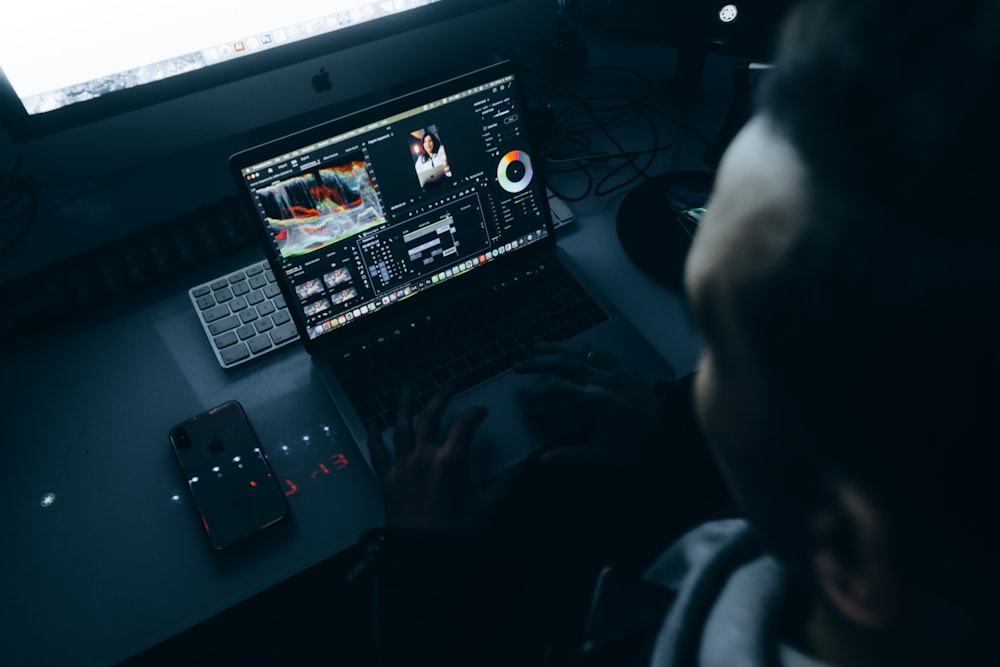 a man sitting in front of a laptop computer