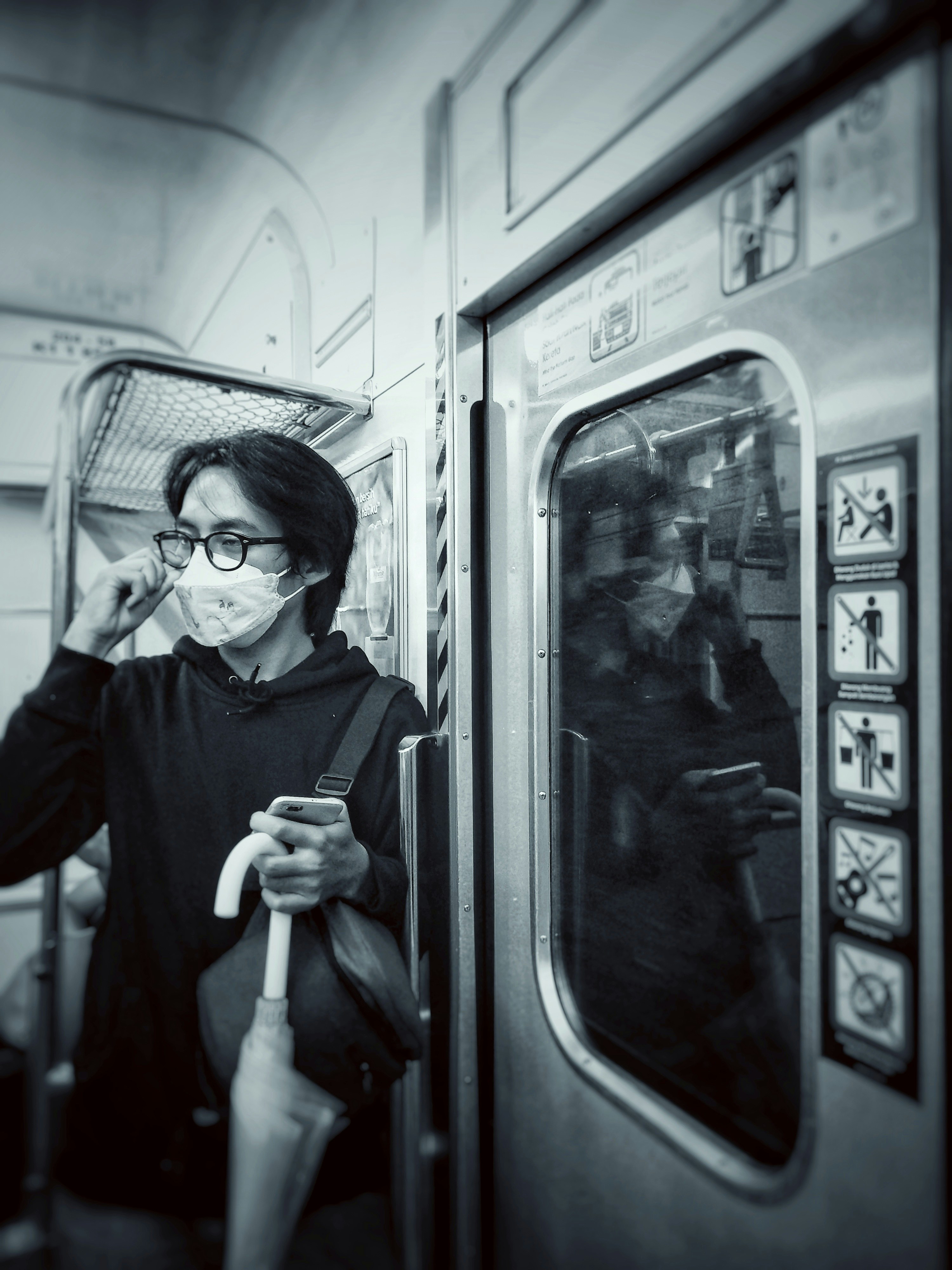 a woman wearing a face mask on a train