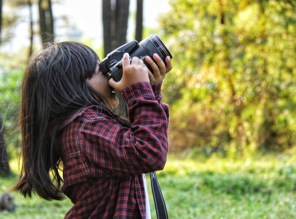 a woman taking a picture with a camera