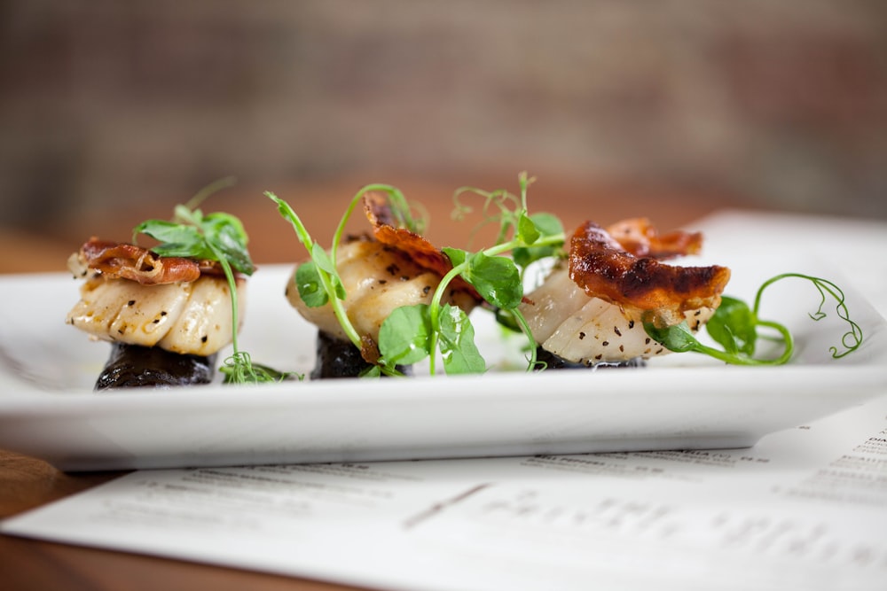 a white plate topped with food on top of a wooden table