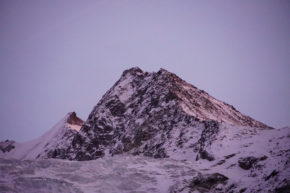 a snow covered mountain with a sky background