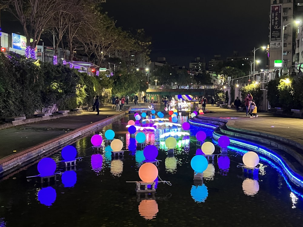 a pond filled with lots of different colored lights