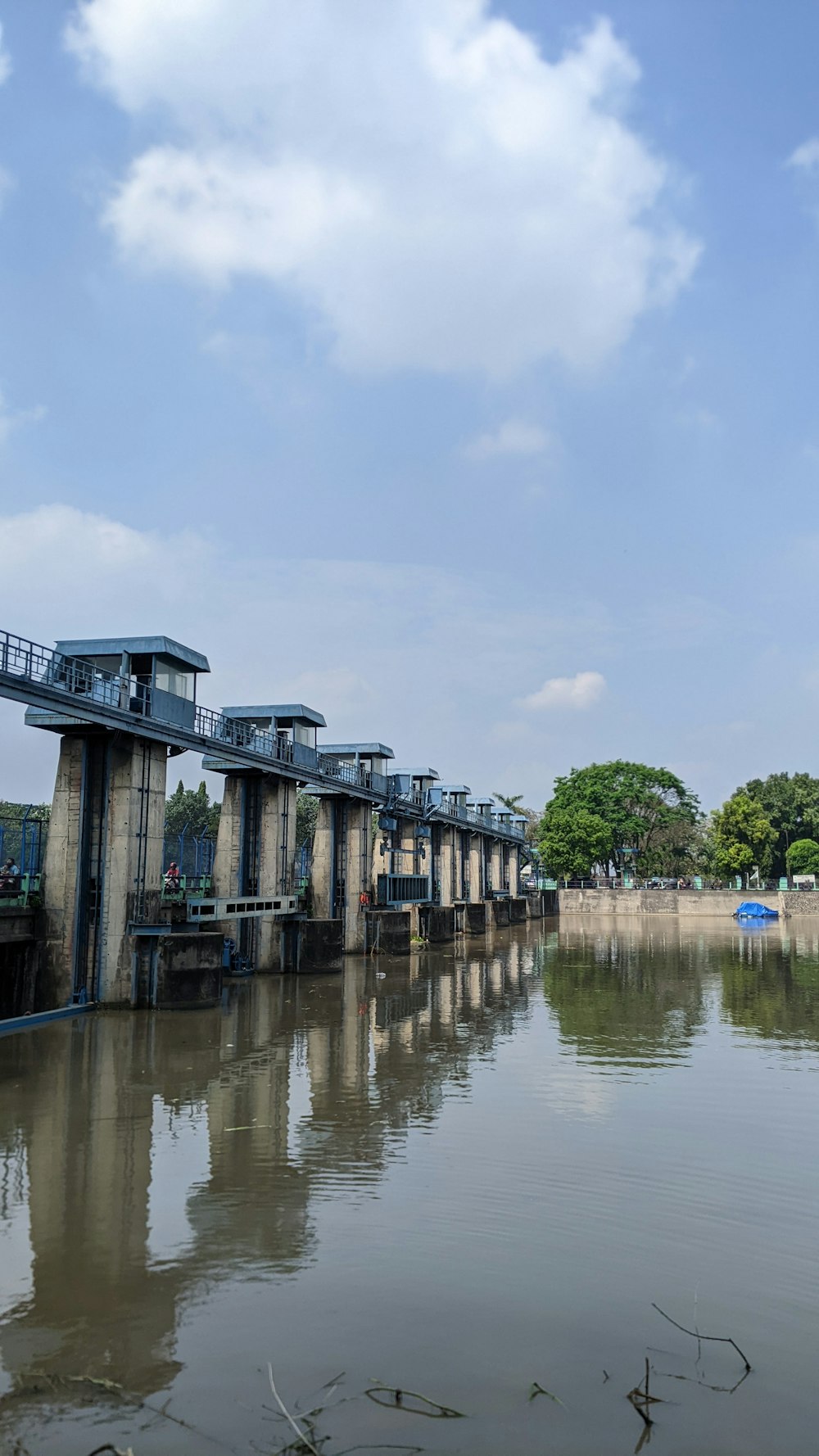 a body of water with a bridge in the background