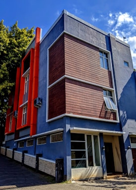 a blue and red building on a street corner