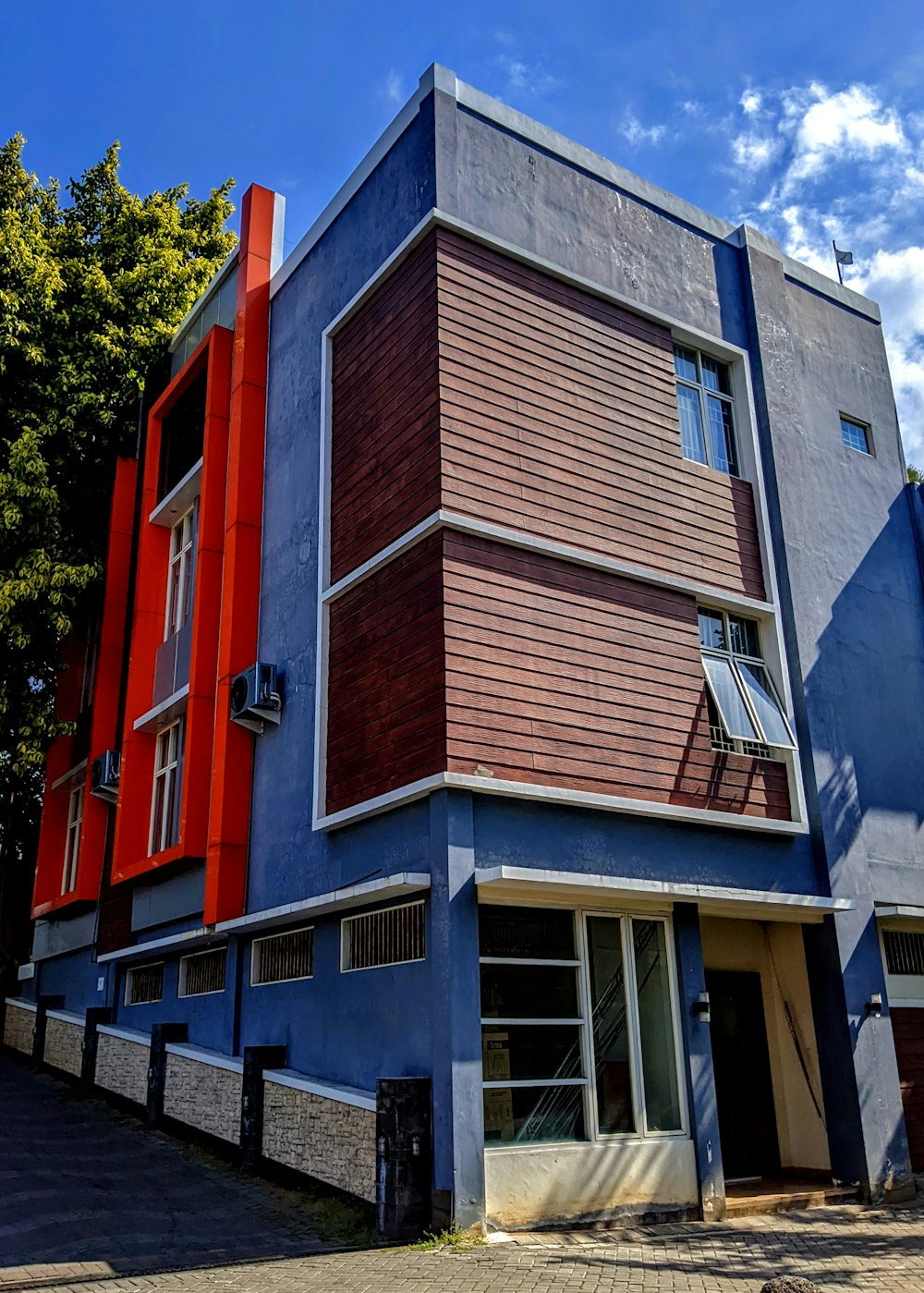 a blue and red building on a street corner