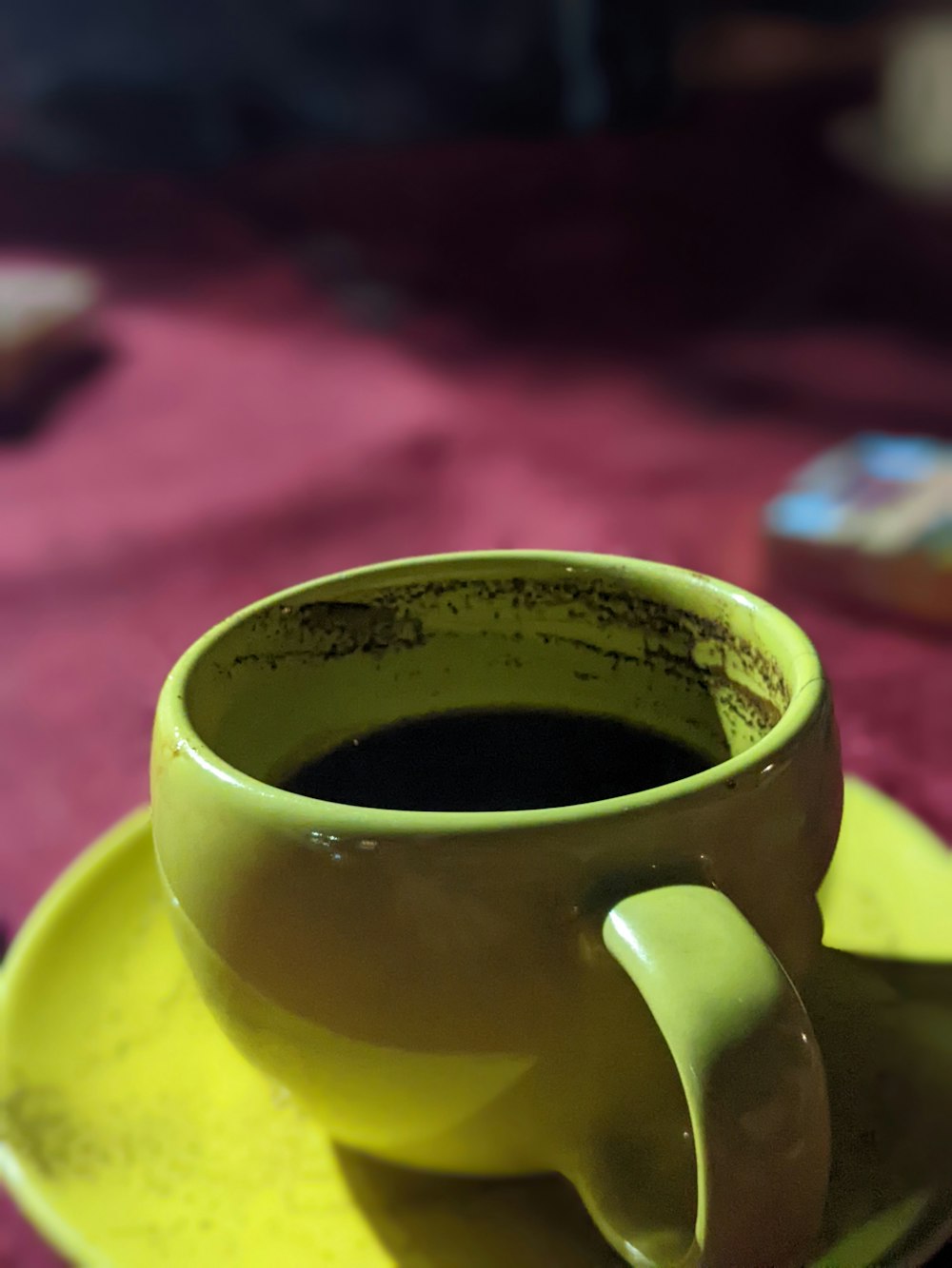 a cup of coffee sitting on top of a yellow saucer