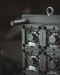 a close up of a metal object with a black and white background