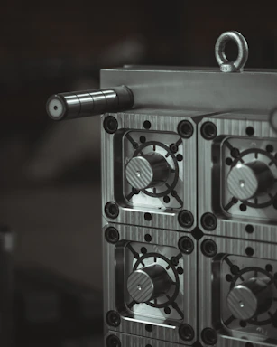 a close up of a metal object with a black and white background