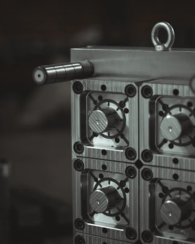 a close up of a metal object with a black and white background