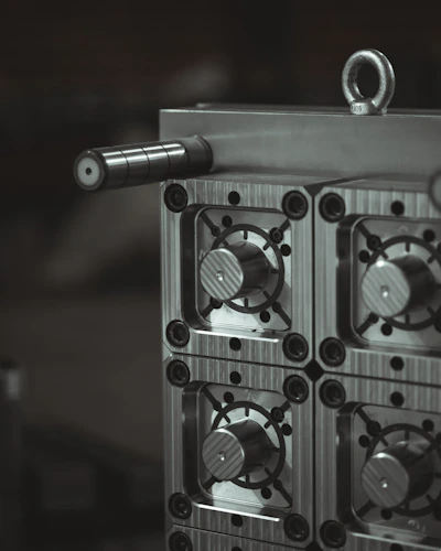 a close up of a metal object with a black and white background