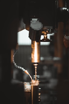 Close-up of CNC machine cutting metal with sparks flying