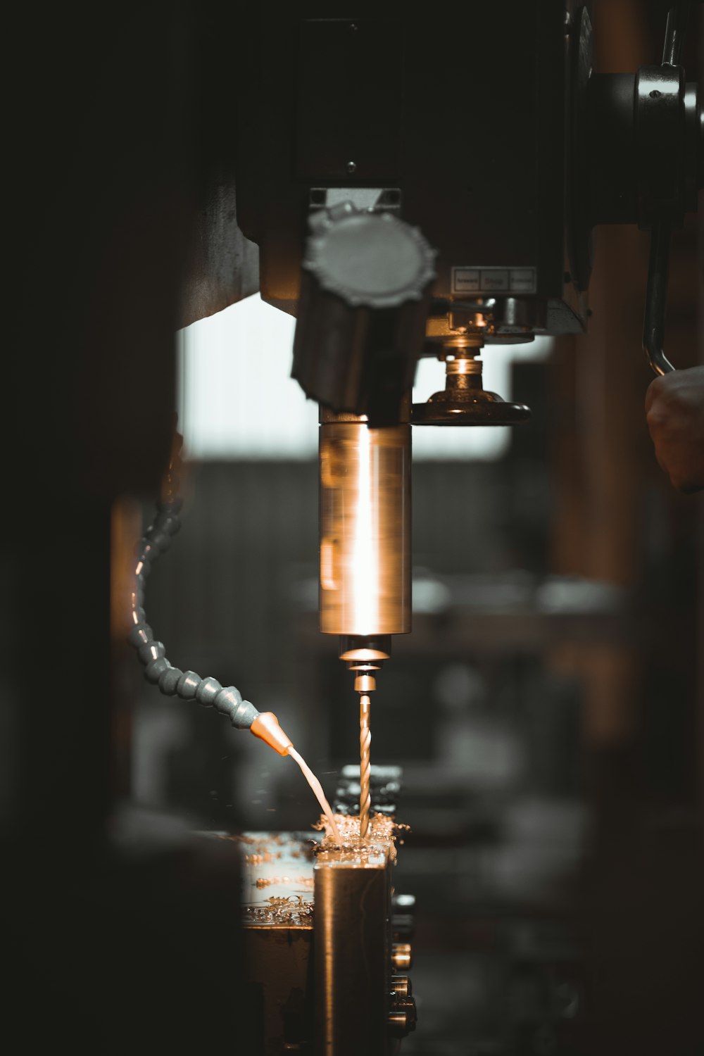 a machine cutting a piece of metal in a factory