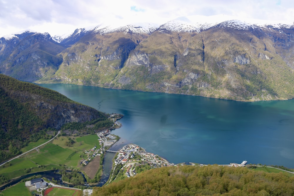 an aerial view of a lake surrounded by mountains