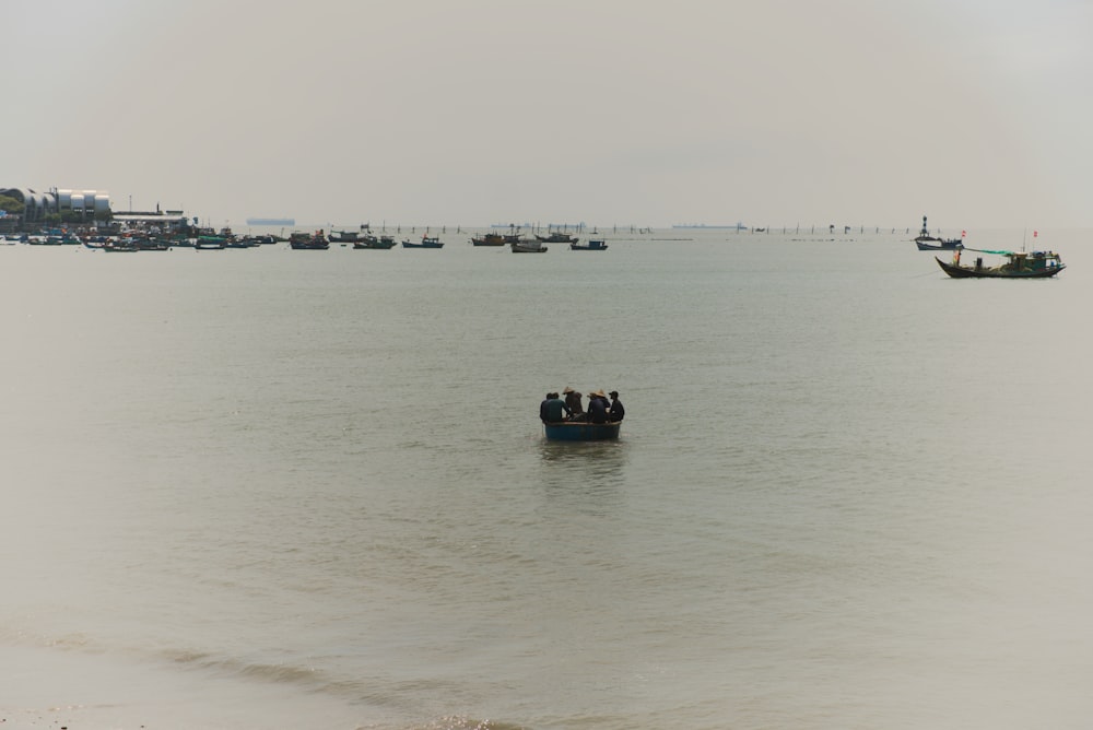 a group of people in a small boat in the water