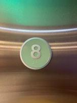 Close-up of braille and raised number symbols on an educational box.