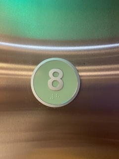Close-up of braille and raised number symbols on an educational box.