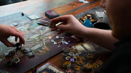 two people playing a board game on a table