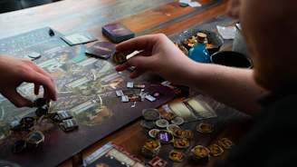 two people playing a board game on a table