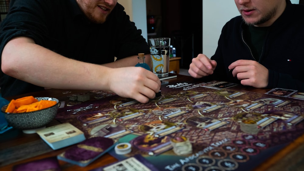 two men sitting at a table playing a board game